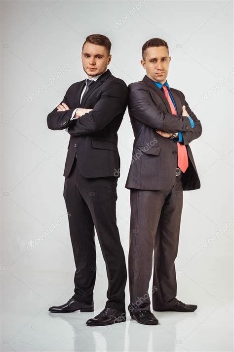Two Business Men Standing Back To Back Isolated Stock Photo By ©caps
