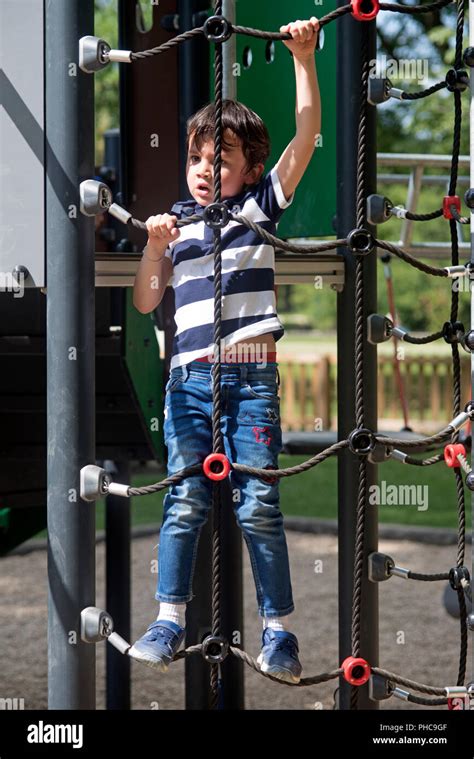 Child Climbing On A Rope Ladder Stock Photo Alamy