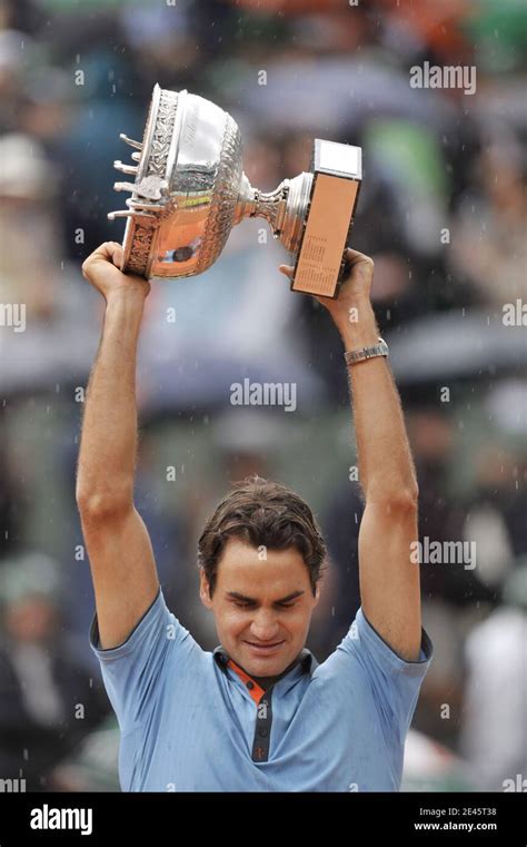 switzerland s roger federer holds the trophy following his victory during the men s singles