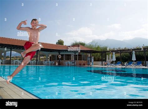 Boy In Mid Air Jumping In Swimming Pool Stock Photo Alamy