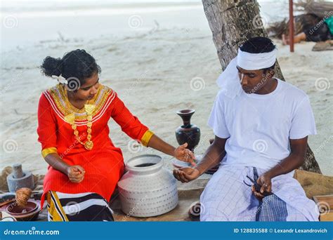 Young Maldivian Couple Dressed In National Clothes Cooking Food