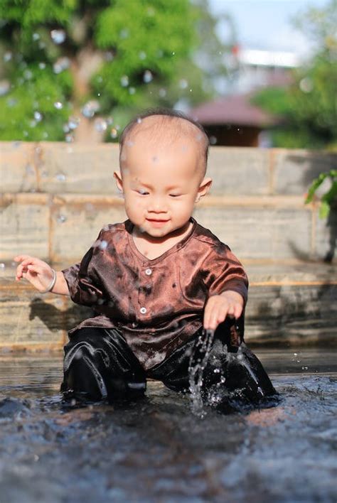 Close Up Of A Cute Boy Playing Water · Free Stock Photo
