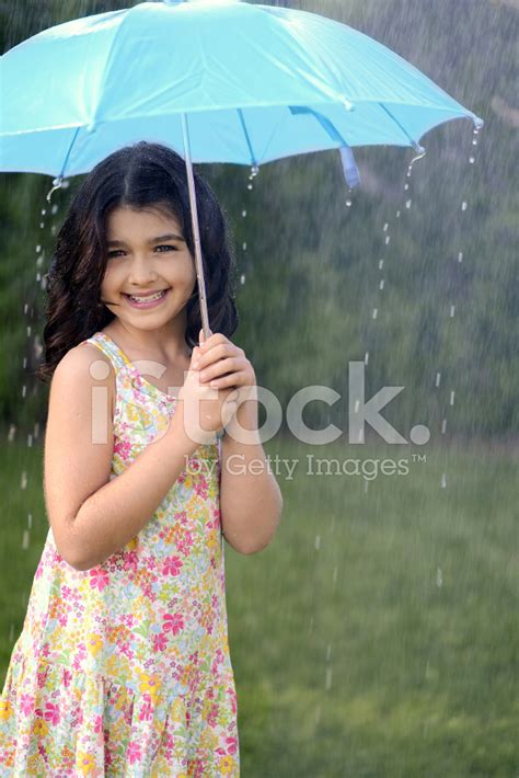 Young Girl Playing In Rain With Umbrella Stock Photo Royalty Free