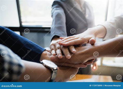 Group Of Business People Putting Their Hands Working Together On Wooden