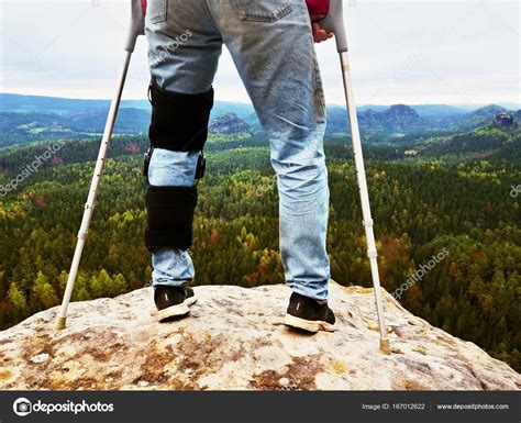Man Walking With Crutches In Nature Man Legs In Jeans With Adjustable
