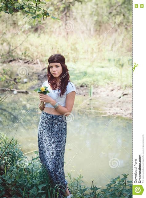 Portrait Of Hippie Girl In Forest With Flowers Stock Photo