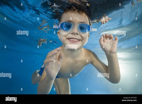 Young Boy Wearing Swimming Goggles Dives In A Pool Stock Photo Alamy