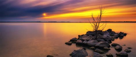 Download Wallpaper 2560x1080 Lake Stones Sunset Water Reflection