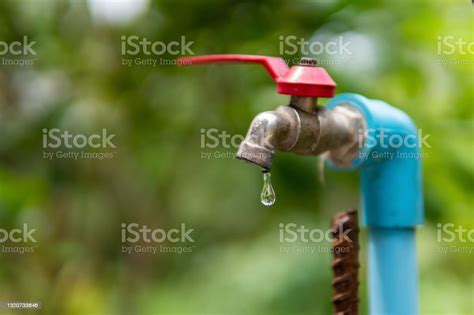 Water Droplets Dripping From The Old Faucet Stock Photo Download