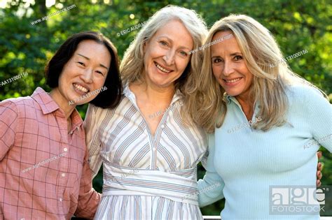 Three Senior Women Posing Together For Group Photo Outdoors Stock