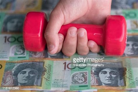 Australian Currency In The Background Along With A Human Hand Holding A