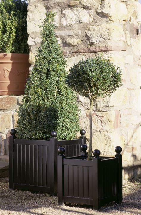 Made from iron with a bronze effect finish. Versailles Planters | Garden Artisans, LLC