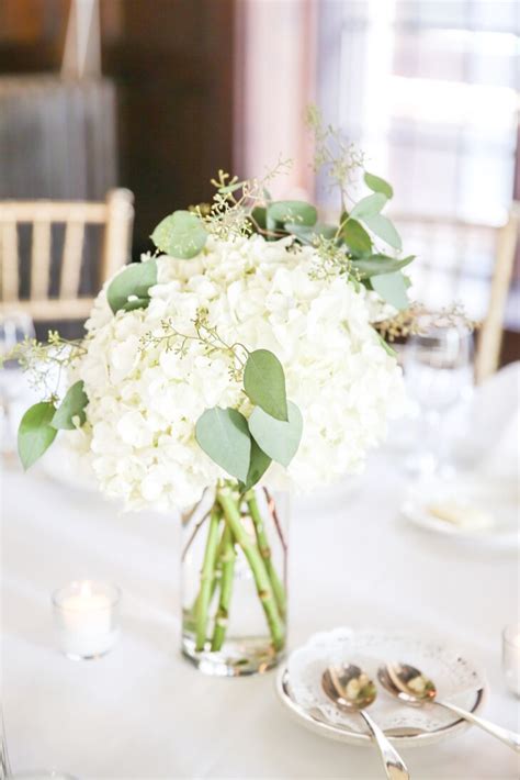 Cream candlesticks ~ wedding decoration of the week. Hydrangea and Eucalyptus Centerpiece