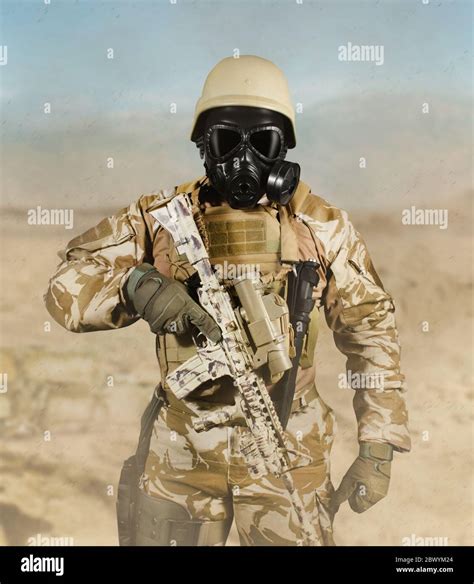 photo of a fully equipped soldier in uniform armor helmet and gas mask standing with rifle in