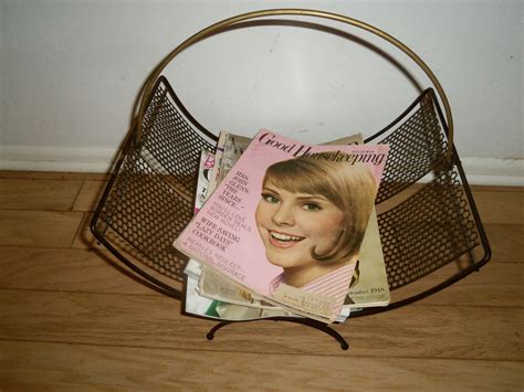 Maybe you would like to learn more about one of these? Vintage Atomic Mid-Century Black Metal Magazine Rack