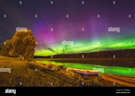 Milky Way And Northern Lights Aurora Borealis Over The River Stock