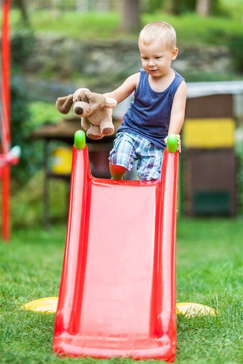 Adorable Child Playing On The Slide Stock Photo Image Of Small