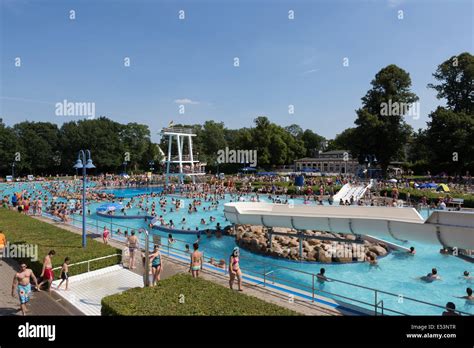 Crowded Outdoor Swimming Pool Full Of People Bathing In Germany On A