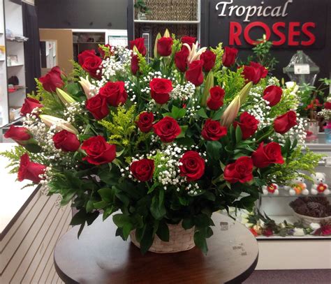 Arrangement With Red Roses And Lilies In A Basket