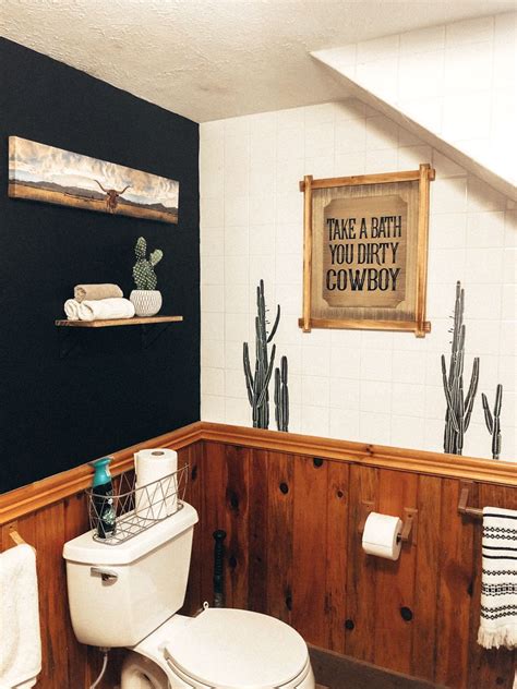 A Bathroom With Black Walls And Wooden Paneling White Toilet And