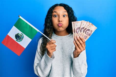 Young Latin Woman Holding Mexico Flag And Mexican Pesos Banknotes