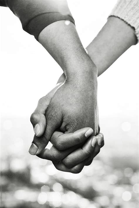 Closeup Of Couple Holding Hands Outside Black And White