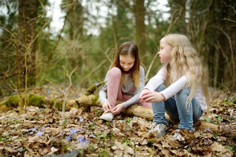 Two Cute Young Sisters Having Fun During Forest Hike On Beautiful Early Spring Day Active