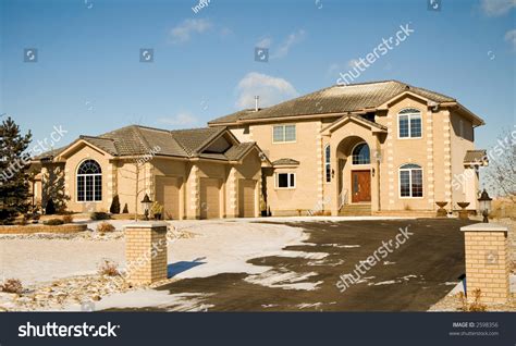 Two Story Upper Class Brick Luxury Home With Triple Garage Stock Photo