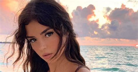 Demi Rose Bends Over To Expose Bust On Beach