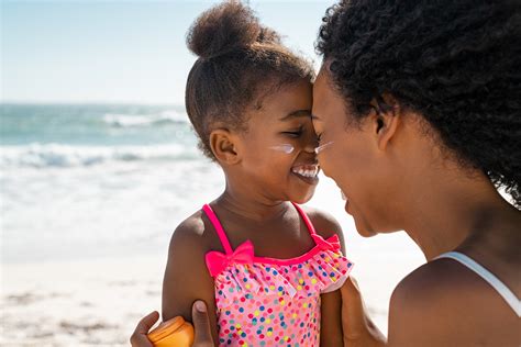 Woman Hugging Lovely Daughter With Sunscreen On The Cheeks Dermatology Laser And Vein