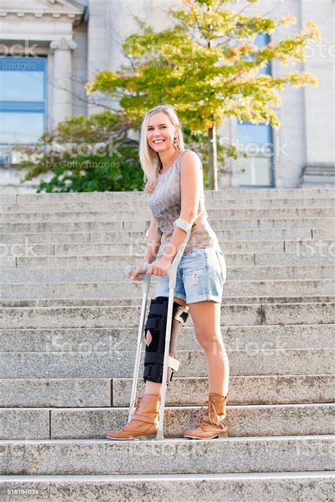 Blonde Woman With Crutches Stock Photo Download Image Now Istock