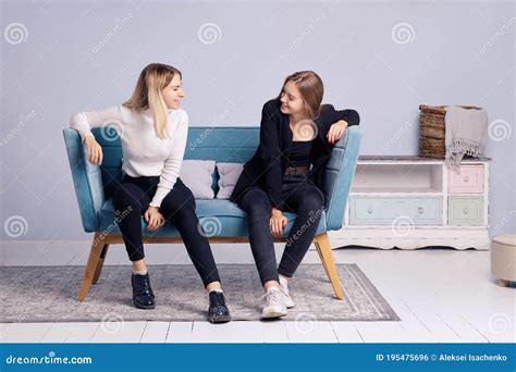 Two Girls Talking Together On The Couch Friendship And Teenager