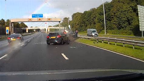 dashcam footage shows car smash into broken down vehicle on m62 inches from man on phone