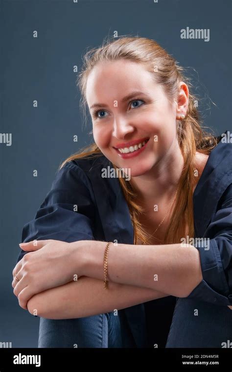 Very Positive Smiling Young Blonde Woman Sitting On The Floor Stock