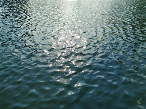 Water Surface With Small Waves The Sunlight Gives A Gleam In The