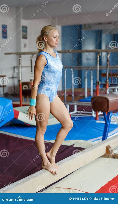 Positive Mature Woman Acrobat In Bodysuit Exercising Gymnastic Action