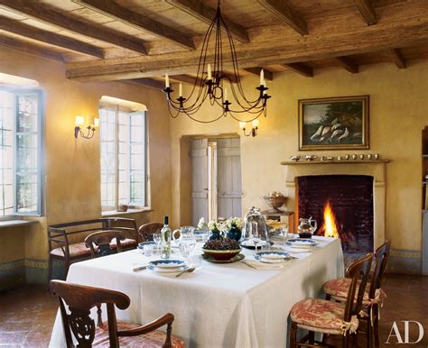 A Dining Room With A Table Set For Four And A Fire Place In The Corner