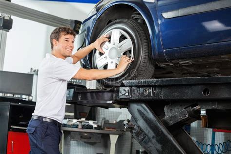 Smiling Mechanic Fixing Alloy To Car Tire Stock Image Image Of Alloy