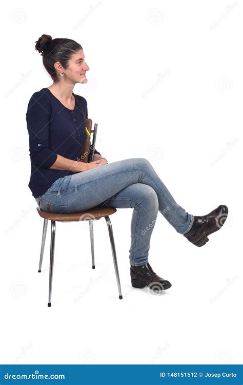 Full Portrait Of A Woman Sitting On A Chair Cross Legged And Looking To