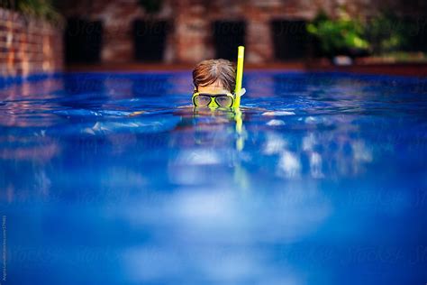 Boy Wearing A Snorkel Set In A Pool By Stocksy Contributor Angela