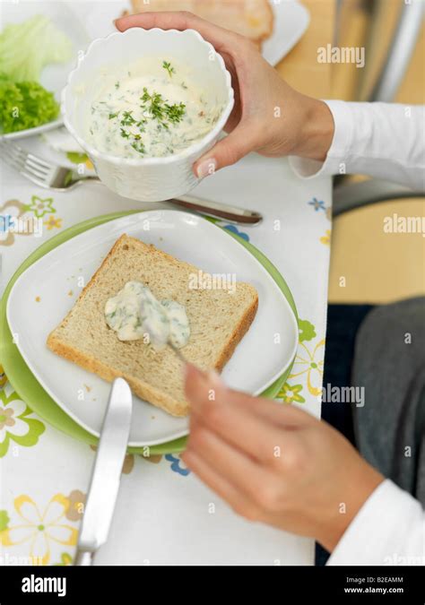Person S Hands Spreading Cream Cheese On Slice Of Bread Stock Photo Alamy