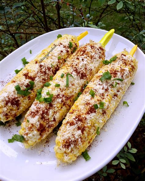 Grilled Corn And Loaded With Mayonnaise Sour Cream Parmesan Cheese