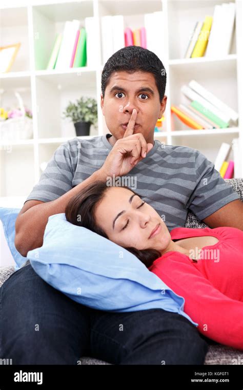 Young Beautiful Woman Sleeping Man Holding Finger To Lips As A Sign
