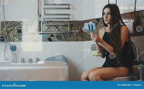 Girl Sitting On Toilet In Bathroom Take Selfie On Blue Monopod Posing Stock Footage Video Of