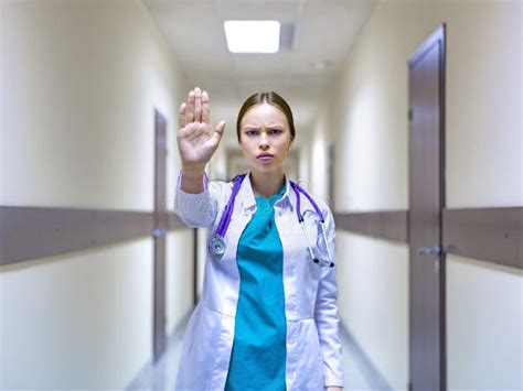 Serious Female Doctor With Stethoscope Showing Stop Sign In The