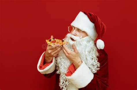 Funny Santa Eating Delicious Pizza On Red Background And Looking Into