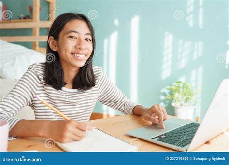Asian Girl Learning Online Via The Internet Tutor On A Laptop Computer