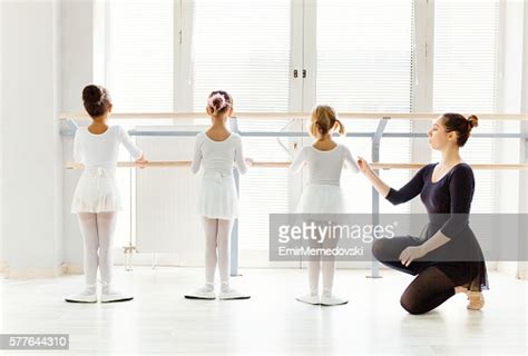 Ballet Teacher Helping Girls With Postures During Ballet Class Photo