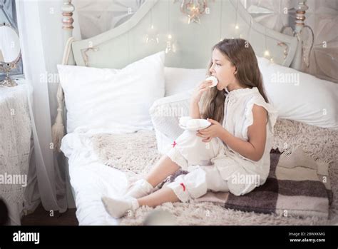 Girl Eating Dessert In The Bedroom On The Bed Stock Photo Alamy