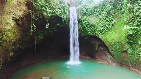 Tibumana Waterfall With Its Spiritual Faith Palm Living